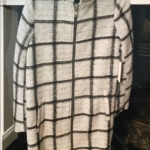 Black and white light weight zipper front coat.